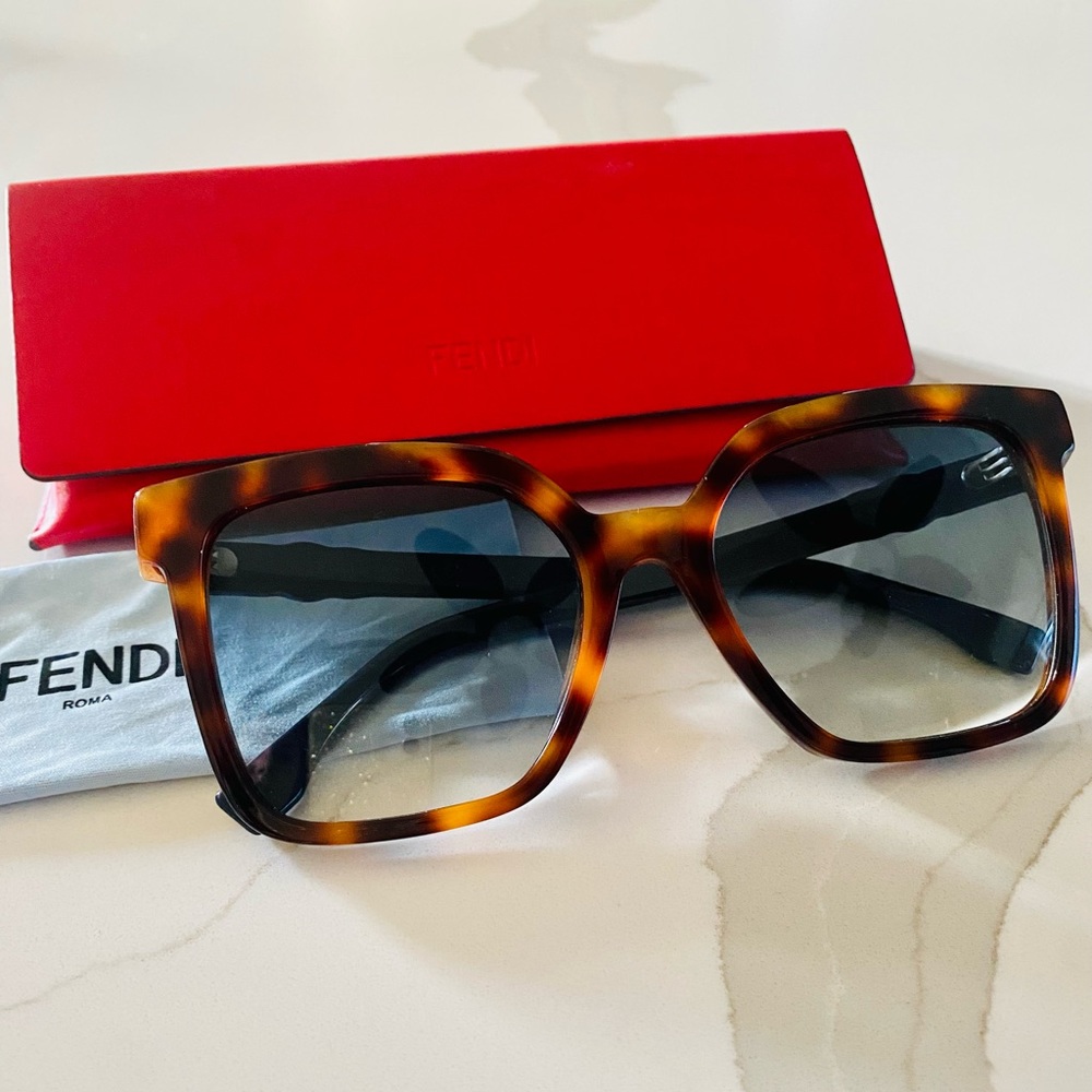 Fendi sunglasses, tortoise shell coloring with pale blue lenses + logo on side